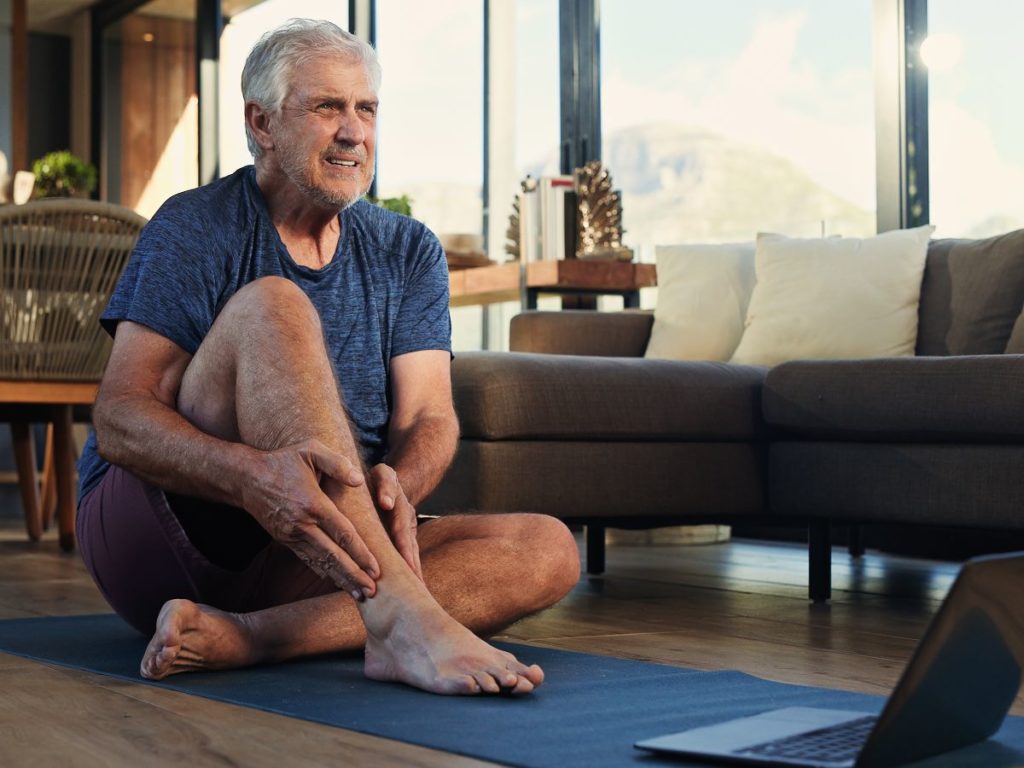 person holding ankle arthritis pain