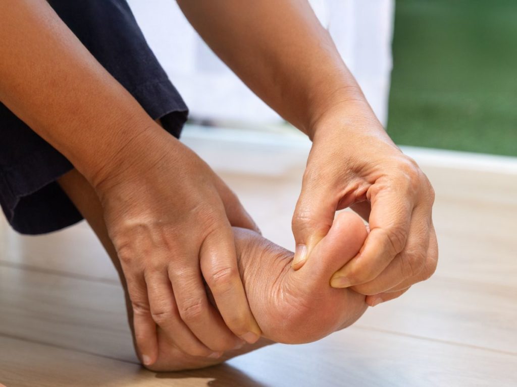 person holding big toe pain
